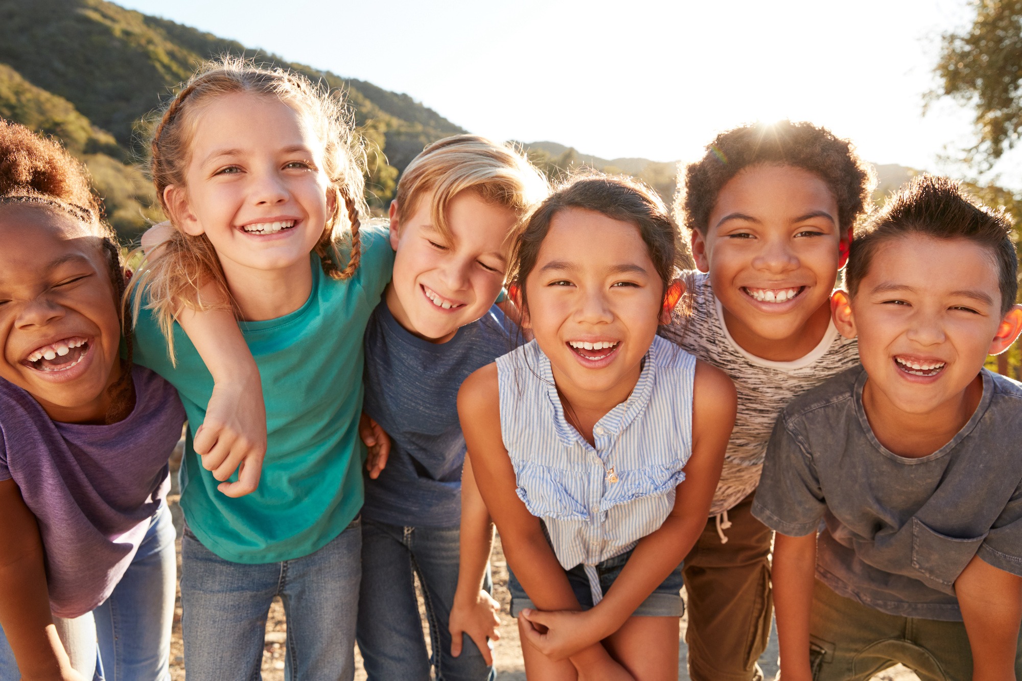 group of kids laughing and smiling outside